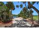 Private boat ramp leading to the water with lush tropical landscaping at 1227 Osowaw Blvd, Spring Hill, FL 34607