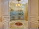 Stunning hallway with Venetian-inspired mural and decorative flooring at 1227 Osowaw Blvd, Spring Hill, FL 34607
