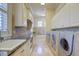 Large laundry room with granite counters, built-in cabinets and high-end appliances at 1227 Osowaw Blvd, Spring Hill, FL 34607