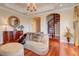 Elegant sitting area features a spiral staircase, hardwood floors, and ornate furniture at 1227 Osowaw Blvd, Spring Hill, FL 34607
