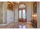 Elegant entryway with double doors, marble floors, and detailed wall finishes at 1227 Osowaw Blvd, Spring Hill, FL 34607