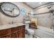 Bathroom with a wooden vanity, a large mirror, and a shower/tub combo at 2289 Republic Dr, Dunedin, FL 34698