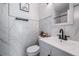 Modern bathroom with white vanity, marble-style tile, and black fixtures at 2289 Republic Dr, Dunedin, FL 34698