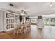 Bright dining area with a farmhouse table and chairs, adjacent to the kitchen and living room at 11600 7Th E St, Treasure Island, FL 33706