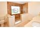 Bathroom featuring a unique stone shower with a window and bench at 10799 Harborside Dr, Largo, FL 33773