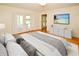 Bright and airy bedroom with white decor, featuring a large bed, television, and access to the lanai at 10799 Harborside Dr, Largo, FL 33773