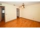 Bedroom with hardwood floors, ceiling fan and view of a closet and doorway at 10799 Harborside Dr, Largo, FL 33773