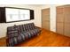 Bedroom featuring hardwood floors, a futon, and a double closet at 10799 Harborside Dr, Largo, FL 33773