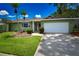 Well-maintained home with a lush front lawn and a spacious driveway at 10799 Harborside Dr, Largo, FL 33773