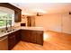 Modern kitchen featuring stainless steel appliances, granite countertops, and dark wood cabinets, and wood floors at 10799 Harborside Dr, Largo, FL 33773