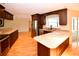 Bright kitchen featuring stainless steel appliances, granite countertops, and dark wood cabinets, with wood floors at 10799 Harborside Dr, Largo, FL 33773