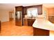 Well-lit kitchen with stainless steel appliances, granite countertops, and dark wood cabinets, with wood floors at 10799 Harborside Dr, Largo, FL 33773