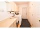 Laundry room with washer, dryer, sink, cabinetry and access to exterior at 10799 Harborside Dr, Largo, FL 33773