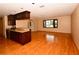 Bright and airy living room featuring hardwood floors and bar to kitchen at 10799 Harborside Dr, Largo, FL 33773