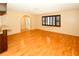 Spacious living room with hardwood floors, arched doorway and dark shutters at 10799 Harborside Dr, Largo, FL 33773