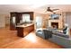 Open-concept kitchen and living room with fireplace, hardwood floors, and ample natural light at 10799 Harborside Dr, Largo, FL 33773