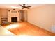 Open living room with hardwood floors, fireplace, ceiling fan, and multiple light sources from above at 10799 Harborside Dr, Largo, FL 33773