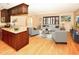Bright living room adjacent to a kitchen island, featuring hardwood floors and stylish decor at 10799 Harborside Dr, Largo, FL 33773