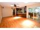Open living room with hardwood floors leading to a kitchen with dark wood cabinets and granite countertops at 10799 Harborside Dr, Largo, FL 33773