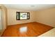 Hardwood floors in a sunny, spacious living room with a large window at 10799 Harborside Dr, Largo, FL 33773