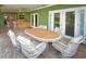 Expansive covered patio with a dining set, a bar, and access to backyard at 10799 Harborside Dr, Largo, FL 33773