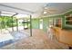 Large screened in patio features a bar, ceiling fans, and brick floors at 10799 Harborside Dr, Largo, FL 33773
