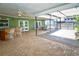 Large covered patio features a bar area, a dining set, and brick flooring at 10799 Harborside Dr, Largo, FL 33773
