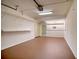 Garage with ample storage shelving and painted floor at 128 1St Street E. # 102, Tierra Verde, FL 33715