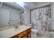 Clean bathroom with a shower/tub combo and marble accents at 128 1St Street E. # 102, Tierra Verde, FL 33715