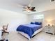 Bright bedroom with blue bedding, ceiling fan, and tile flooring at 180 Altoona Nw St, Port Charlotte, FL 33948