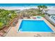 Inviting heated pool with ocean views and a relaxing patio area at 19828 Gulf Blvd # 401, Indian Shores, FL 33785