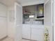 Convenient laundry closet with washer, dryer, and storage shelves at 2585 Bay Berry Dr # 43D, Clearwater, FL 33763
