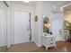 Light and spacious entryway with white door and decorative side table at 2585 Bay Berry Dr # 43D, Clearwater, FL 33763