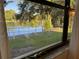 Lake view from window, showcasing tranquil water and greenery at 2585 Bay Berry Dr # 43D, Clearwater, FL 33763