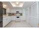 White kitchen with stainless steel appliances and ample cabinet storage at 2585 Bay Berry Dr # 43D, Clearwater, FL 33763