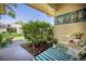Inviting patio with seating area, lush greenery, and nautical-themed art at 2585 Bay Berry Dr # 43D, Clearwater, FL 33763