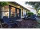 Private patio with two chairs and wood chip ground cover at 2585 Bay Berry Dr # 43D, Clearwater, FL 33763