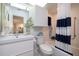 Updated bathroom with white vanity, bathtub, and nautical-themed decor at 2585 Bay Berry Dr # 43D, Clearwater, FL 33763