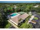 Aerial view of community pool, clubhouse, and surrounding landscape at 2585 Bay Berry Dr # 43D, Clearwater, FL 33763