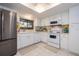 Well-equipped kitchen featuring white cabinets, stainless steel appliances, and tile floor at 2585 Bay Berry Dr # 43D, Clearwater, FL 33763