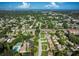 Aerial view of community with houses, pool, and nearby ocean at 2585 Bay Berry Dr # 43D, Clearwater, FL 33763