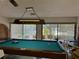 Game room with pool table, overlooking the pool at 2585 Bay Berry Dr # 43D, Clearwater, FL 33763