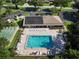 Aerial view showing community pool, surrounding lounge chairs, and shuffleboard at 2585 Bay Berry Dr # 43D, Clearwater, FL 33763