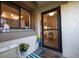 Front entry with glass door, welcome mat, and potted plants at 2585 Bay Berry Dr # 43D, Clearwater, FL 33763