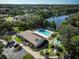Aerial view of community pool, clubhouse, shuffleboard, and parking at 2585 Bay Berry Dr # 43D, Clearwater, FL 33763