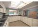 Community kitchen with white cabinets, appliances, and wood-look flooring at 2585 Bay Berry Dr # 43D, Clearwater, FL 33763