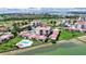 Aerial view of a waterfront community with red tile roofs, lush landscaping, pools, and a picturesque bay setting at 6177 Sun Blvd # 108, St Petersburg, FL 33715