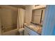 Cozy bathroom features a shower-tub combo and granite vanity at 6177 Sun Blvd # 108, St Petersburg, FL 33715