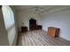 A bright bedroom with wood floors features a TV, dresser, and bedside tables at 6177 Sun Blvd # 108, St Petersburg, FL 33715