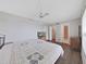 Bright bedroom with a TV, ceiling fan, wood flooring, and bathroom access at 6177 Sun Blvd # 108, St Petersburg, FL 33715